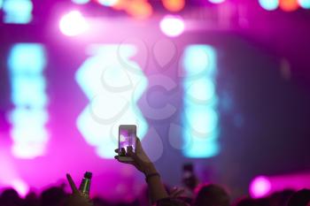 Fan Taking Photo On Mobile Phone At Music Festival