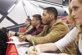 Students listening to lecture at university lecture theatre