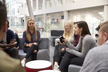 Students meeting in the foyer of modern university building