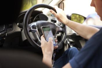 Young Man Using Satellite Navigation on Phone Whilst Driving