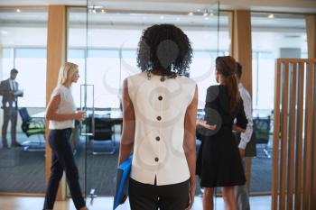 Rear View Of Businesswoman Entering Boardroom For Meeting