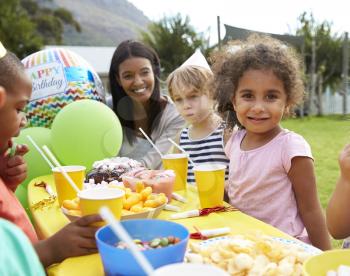 Mother With Children Enjoying Outdoor Birthday Party Together
