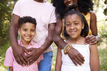 Mid section of black couple and their two children, portrait