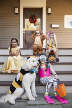 Children And Dog In Halloween Costumes For Trick Or Treating