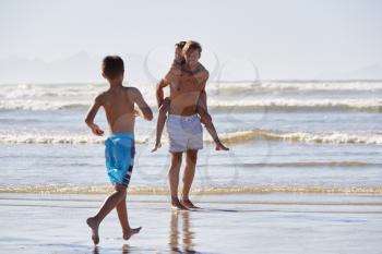 Father With Children Having Fun On Summer Beach Vacation