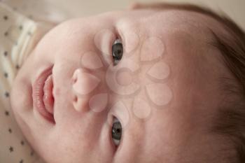 Close Up Of Newborn Baby Boy Lying On Changing Table In Nursery