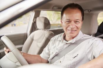 Senior man in car driving seat looking out of side window