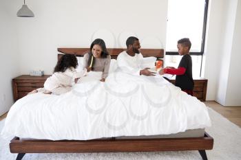 Children Bringing Parents Breakfast In Bed To Celebrate Mothers Day Fathers Day Or Birthday