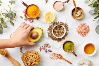 Overhead View Hand Arranging Natural Beauty And Health Products On Marble Background