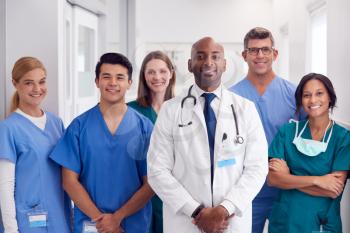 Portrait Of Multi-Cultural Medical Team Standing In Hospital Corridor