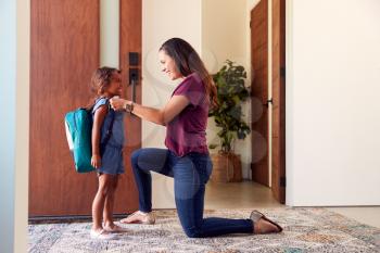 Mother Saying Goodbye To Daughter As She Leaves Home For School