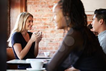 Couple Meeting And Chatting In Coffee Shop Sitting At Table