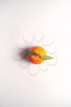 Overhead View Of Fresh Satsuma With Leaf On White Background