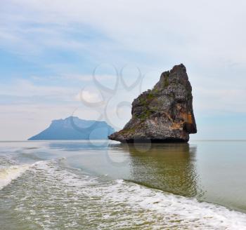 Boat trip in the Gulf of Thailand. The picturesque island-rock float in a sea mist
