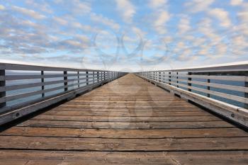 Wooden pier with handrails. Pacific Coast, California, USA
