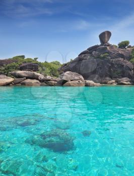 Exotic Similan Islands. Warm and clear azure ocean waters. At the bottom of the bay are visible coral