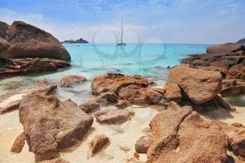 Similansky islands, Andaman Sea, Thailand.
The thinnest white sand of a beach adjoins with huge brown rocks and azure water.