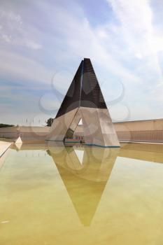 Lisbon, capital of Portugal. War Memorial on the banks of the River Tagus. Obelisk reflected in the smooth water of the pool