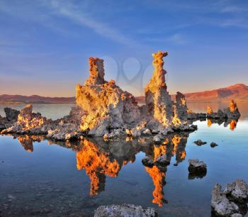 Mono Lake - a natural wonder in the United States. Outliers - bizarre limestone calcareous tufa formation  reflected in the smooth water.