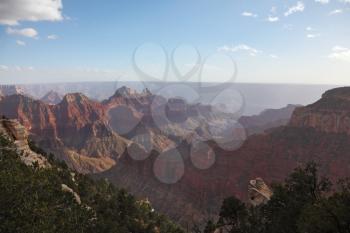 The majestic landscape of the Grand Canyon. Late-afternoon mist rises from the bottom of the canyon