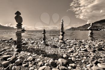  Pyramids from coastal stones combined by the local master - the amateur. Grey scale. 