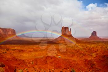 Red stone desert Navajo, USA. Isolated rocks - mitts intersect with the beautiful rainbow