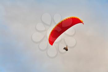 A magnificent parachute in the cloudy sky above the sea
