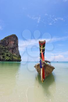 Beautiful, ornate antique boat Longtail on a beach in Thailand
