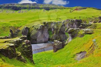  Picturesque rocks with yellowed grass around the canyon Fjadrargljufur. Neverland Iceland