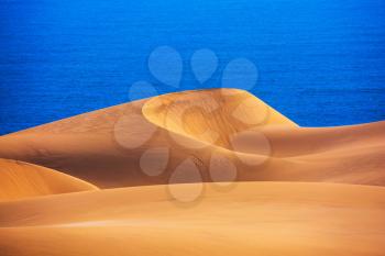 The west coast of the Atlantic Ocean. Giant moving sand dunes. Sandwich Harbour - part of Namib-Naukluft National Park