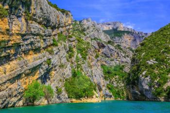 Stony slopes of canyon go down in azure rivers Verdon. National park Merkantur, Provence, France