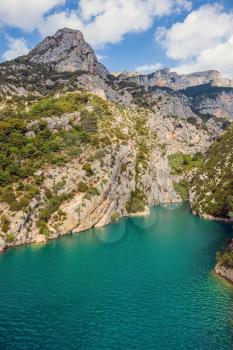 Stony slopes of canyon go down in azure the rivers Verdon. National park Merkantur, Provence