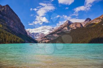 Banff National Park, Canada, Alberta. Magnificent Lake Louise with emerald green water surrounded by the Rocky Mountains, pine forests and glaciers