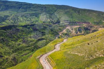 Serpentine road winds through the green hills. Israel's border with Jordan about the hot springs of Hamat Gader