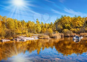 Old Pinawa Dam Provincial Heritage Park. The concept of travel Around the World.  Yellow autumn grass and pale northern sun is reflected in the Winnipeg River