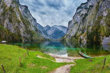 Fishing boats with a small engine in shallows of the lake. The magic blue lake Obersee in Bavarian Alps. Concept of active tourism and ecological tourism