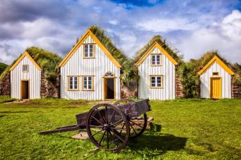 Houses and ancient rural two-wheeled wheelbarrow. The concept of the historical and cultural tourism. Interesting ethnographic museum Glaumbaer in Iceland
