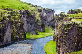The most beautiful canyon in Iceland - Fyadrarglyufur. Steep vertical cliffs surround the stream of very cold water