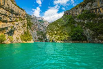 The rocky slopes of canyon Verdon descend into azure water of the river. Mercantour National Park, Provence
