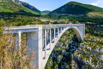 The picturesque deep Verdon Gorge in the Mercantour Park. Grandiose bridge over the mountain canyon Verdon, Southern France, Provence. The concept of active and extreme tourism