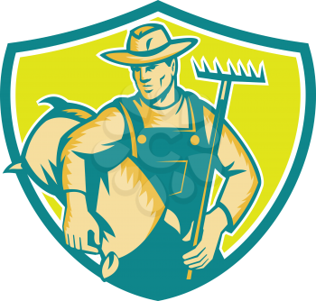Illustration of organic farmer wearing hat and overalls holding rake and carrying sack viewed from the front set inside shield crest done in retro woodcut style. 