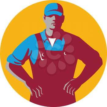 Illustration of an organic farmer wearing hat and overalls with hands on hips akimbo facing front set inside circle on isolated background done in retro style. 