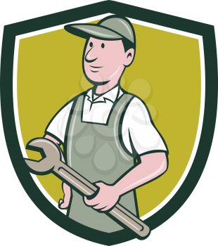 Illustration of a repairman handyman worker wearing hat and overalls holding spanner wrench looking to the side viewed from front set inside shield crest done in cartoon style. 