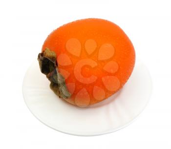 Royalty Free Photo of a Persimmon on a Plate