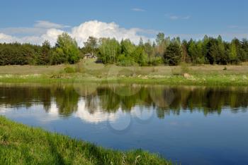 Royalty Free Photo of a Cloud in the Sky Over the Vilija River on a Spring Afternoon.