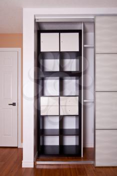 Built-in closet with sliding door shelving storage organization solution, empty shelves