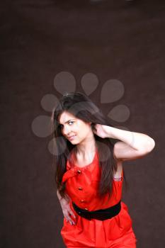 sexy slim woman in red Vintage dress on brown background