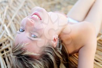 beautiful young woman laying on cane closeup looking at camera