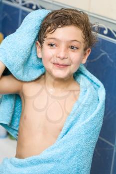 boy after bath warped in blue towel