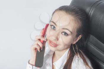 Beautiful young woman working in the room using mobile phone indoors smiling closeup